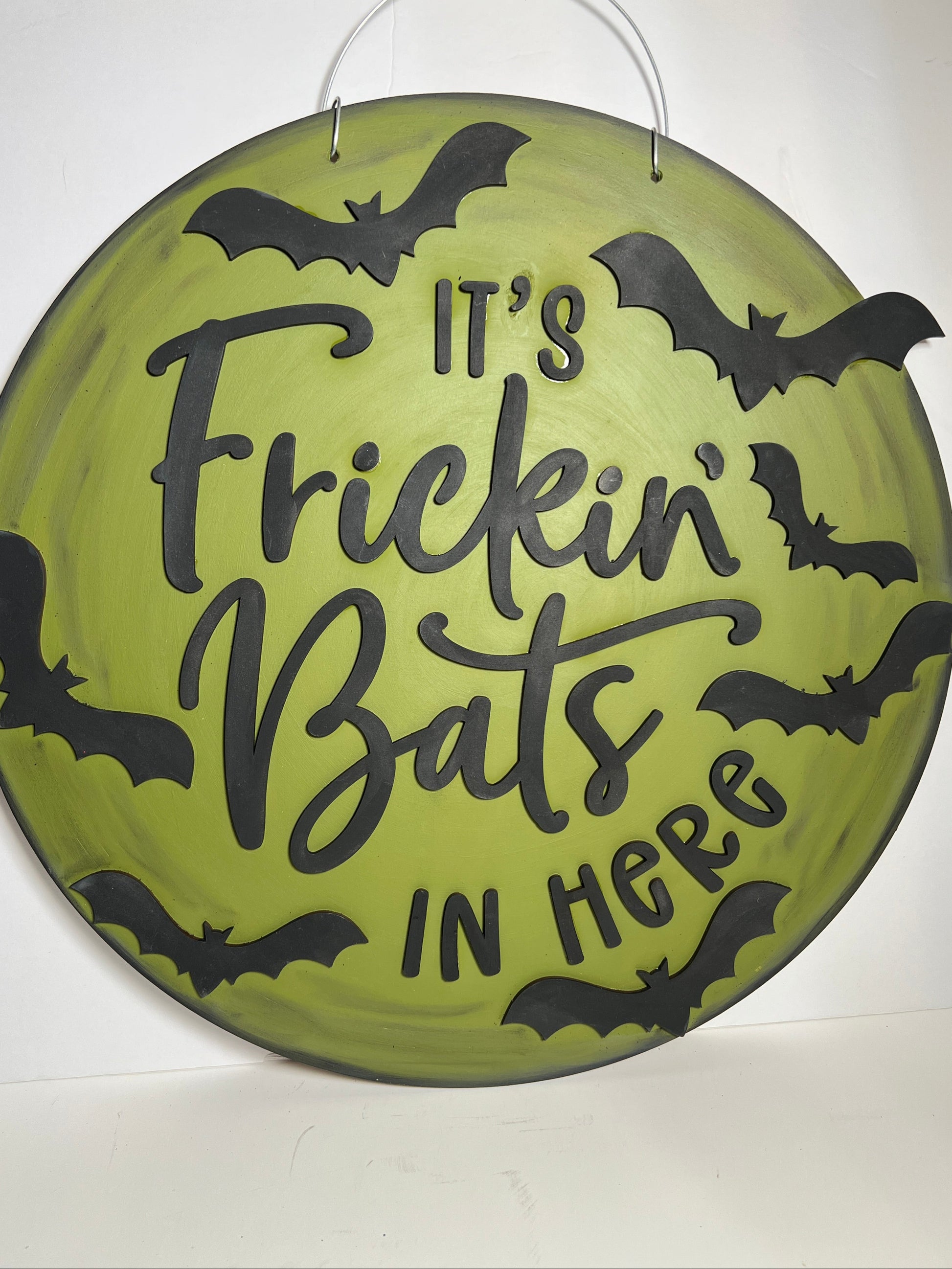 Halloween-themed decorative plate with text "its frickin bats in here" and bats on a green background