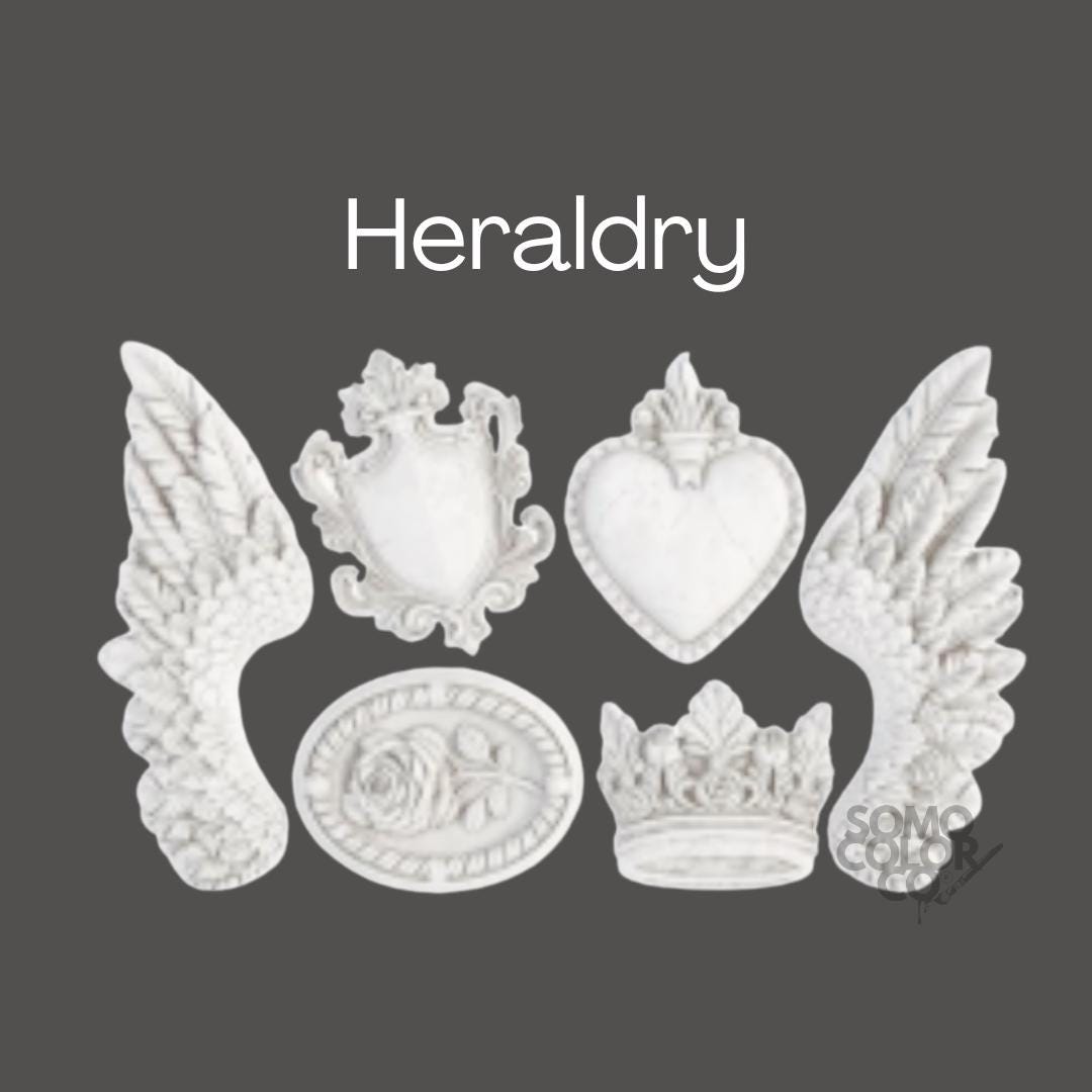 Decorative elements including wings, a heart, a crown, and a shield on a dark background with 'Heraldry' text.
