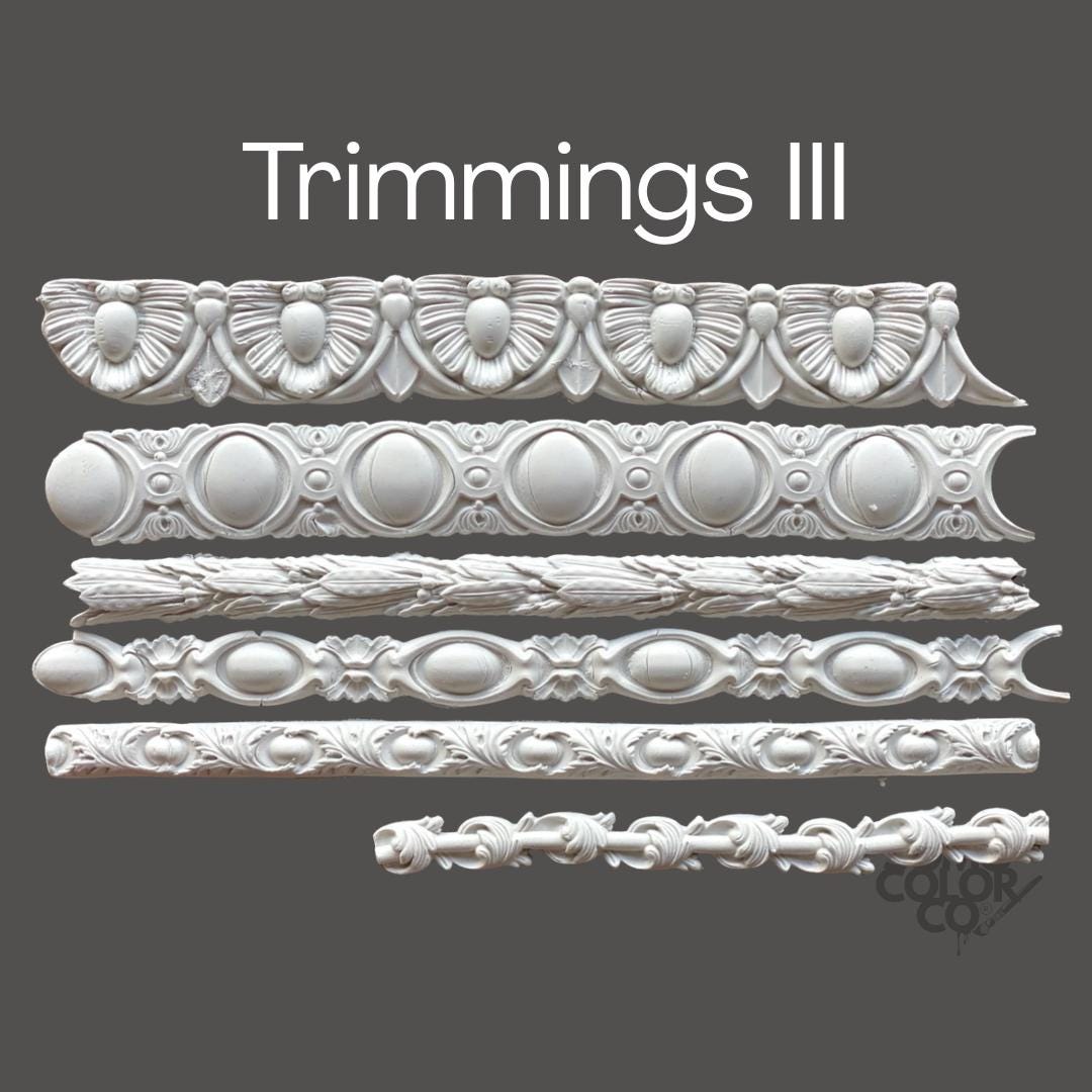 Decorative cornice trim pieces on a gray background with 'Trimmings III' text.