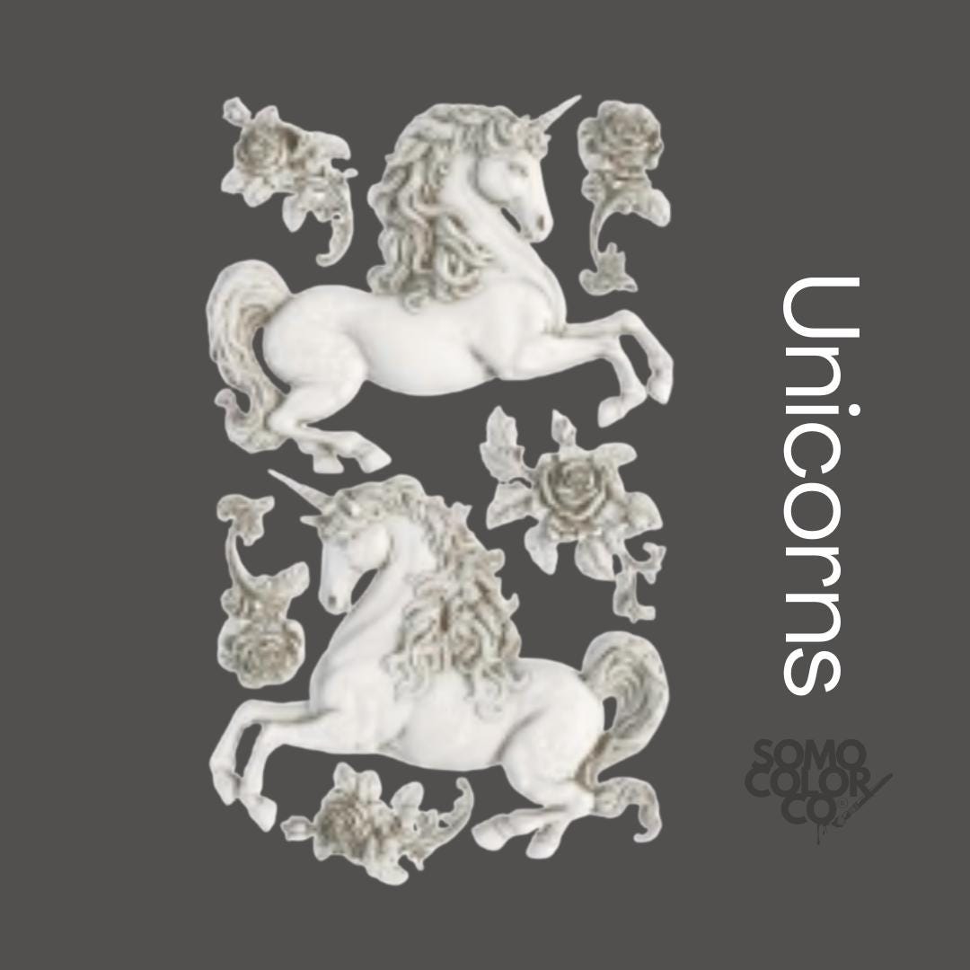 Decorative design with unicorns and floral elements on a dark background, featuring the brand 'SOMO COLOR'.